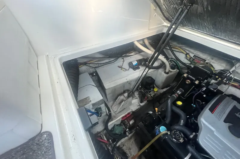 Slide: The Image of Engine compartment of a 2008 Bayliner 245 Cruiser boat, showing mechanical components. - 23