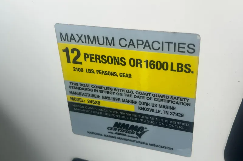 Slide: The Image of 2008 Bayliner 245 Cruiser capacity label: 12 persons or 1600 lbs, US Coast Guard compliant. - 25