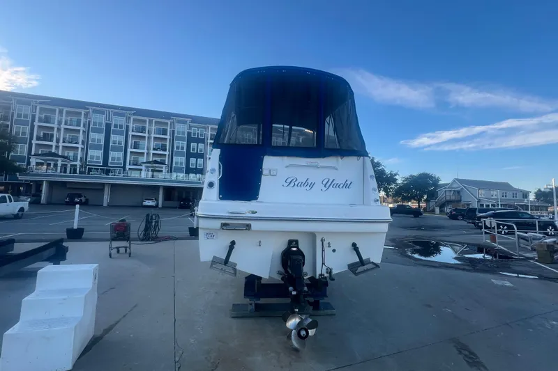 Slide: The Image of 2008 Bayliner 245 Cruiser "Baby Yacht" docked in a marina with buildings in the background. - 34