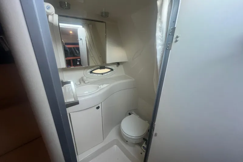 Slide: The Image of 2008 Bayliner 245 Cruiser bathroom with sink, mirror, and toilet. - 8