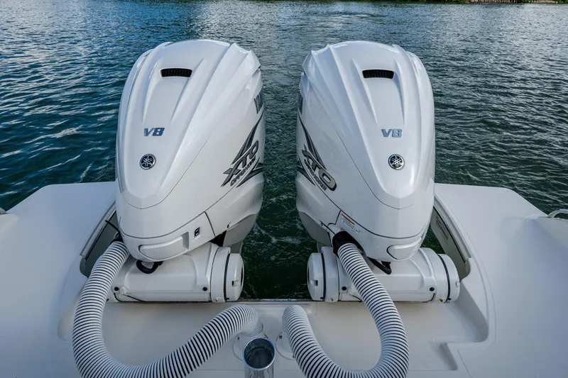 Slide: The Image of Twin V8 engines on a 2023 Pursuit S 358 Sport boat, docked on water. - 16