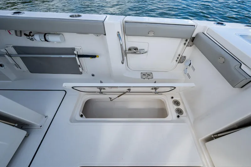 Slide: The Image of 2023 Pursuit S 358 Sport boat deck with storage compartment open. - 18