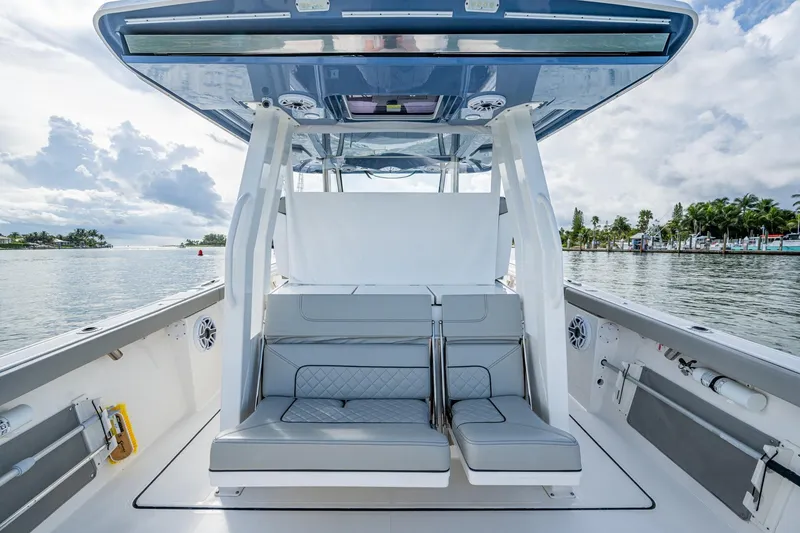Slide: The Image of 2023 Pursuit S 358 Sport boat interior with seating, on a calm waterway. - 25