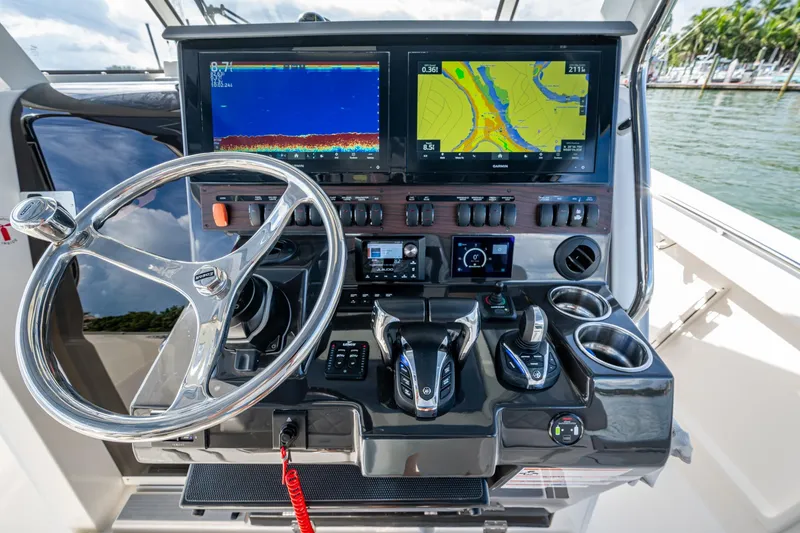 Slide: The Image of 2023 Pursuit S 358 Sport boat dashboard with advanced navigation displays and controls. - 32