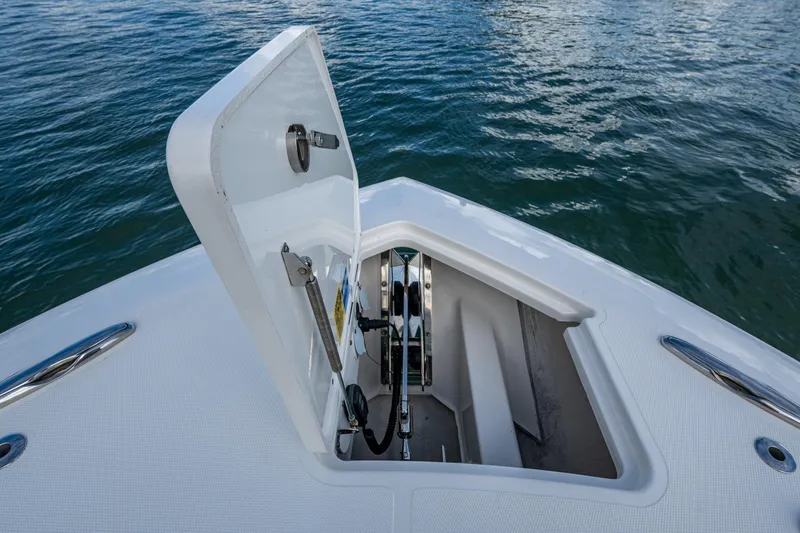 Slide: The Image of 2023 Pursuit S 358 Sport boat anchor compartment open on water. - 39
