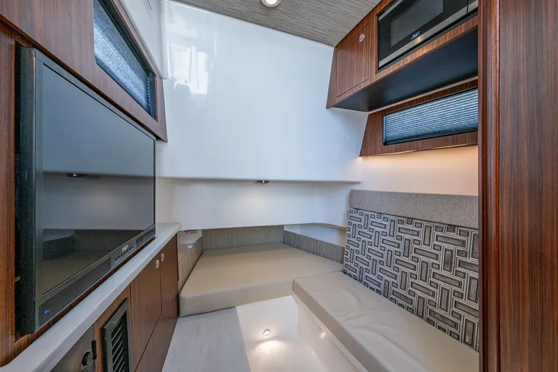 Slide: The Image of 2023 Pursuit S 358 Sport cabin interior with modern design and wood accents. - 48