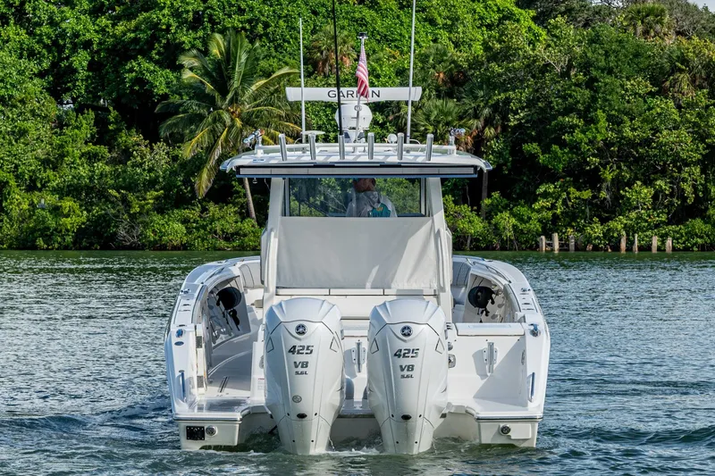 Slide: The Image of 2023 Pursuit S 358 Sport boat with twin engines on a scenic waterway. - 7