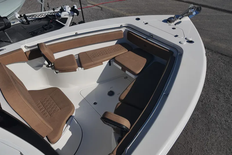 Slide: The Image of 2023 Sea Pro boat with brown cushioned seating and modern design. - 11