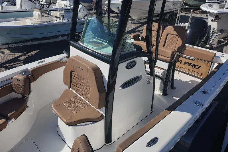 Slide: The Image of 2023 Sea Pro boat interior with brown cushioned seating and modern design. - 14