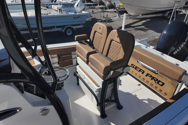 Slide: The Image of 2023 Sea Pro boat interior with brown seating and steering wheel. - 16