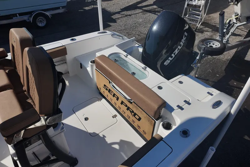 Slide: The Image of 2023 Sea Pro boat with Suzuki outboard motor, featuring brown seating and white deck. - 18