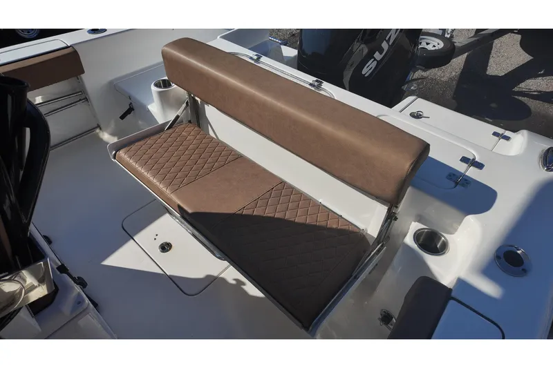 Slide: The Image of 2023 Sea Pro boat with brown cushioned seating and cup holders. - 19