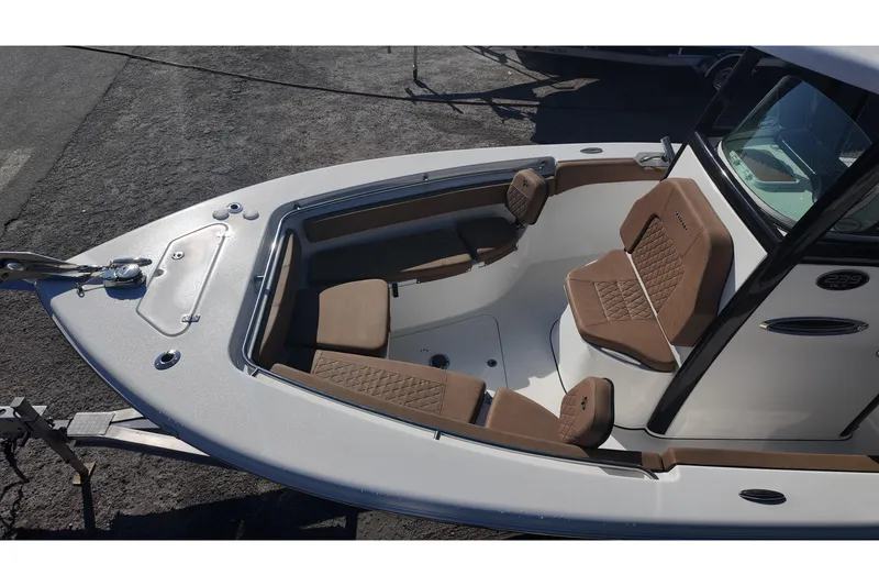 Slide: The Image of 2023 Sea Pro boat interior with brown cushioned seating and modern design. - 21