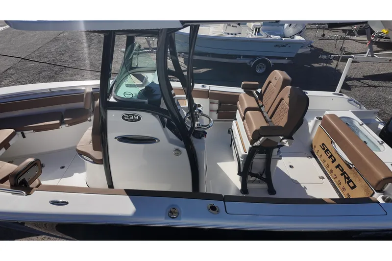 Slide: The Image of 2023 Sea Pro boat interior with brown seating and steering console. - 22