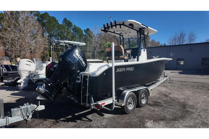 Slide: The Image of 2023 Sea Pro boat on trailer with Suzuki outboard motor, parked outdoors. - 4