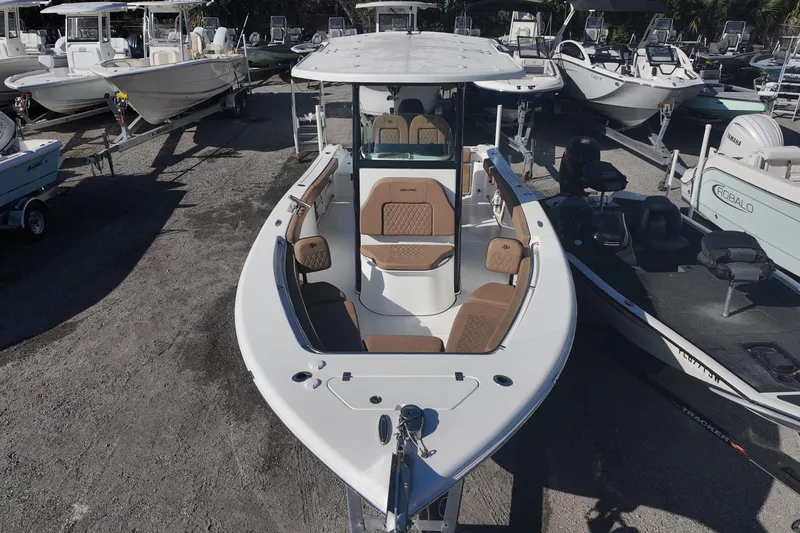 Slide: The Image of 2023 Sea Pro boat with brown seating, docked among other boats. - 5