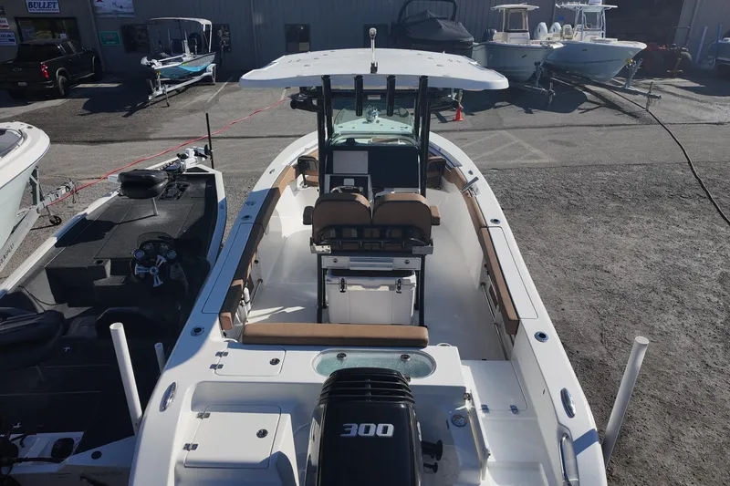 Slide: The Image of 2023 Sea Pro boat with powerful engine, docked in a marina, showcasing spacious interior. - 6