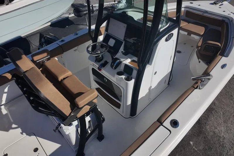 Slide: The Image of 2023 Sea Pro boat interior with brown seating and modern console. - 8