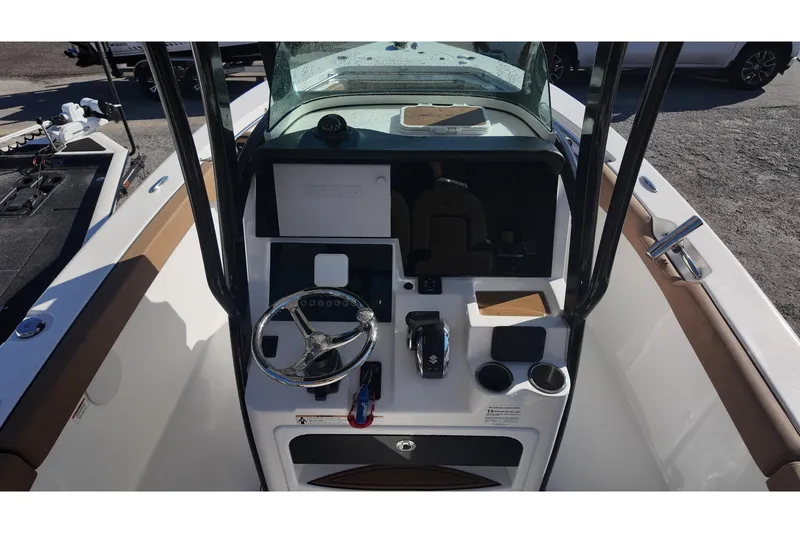 Slide: The Image of 2023 Sea Pro boat dashboard with steering wheel and controls, featuring modern design elements. - 9