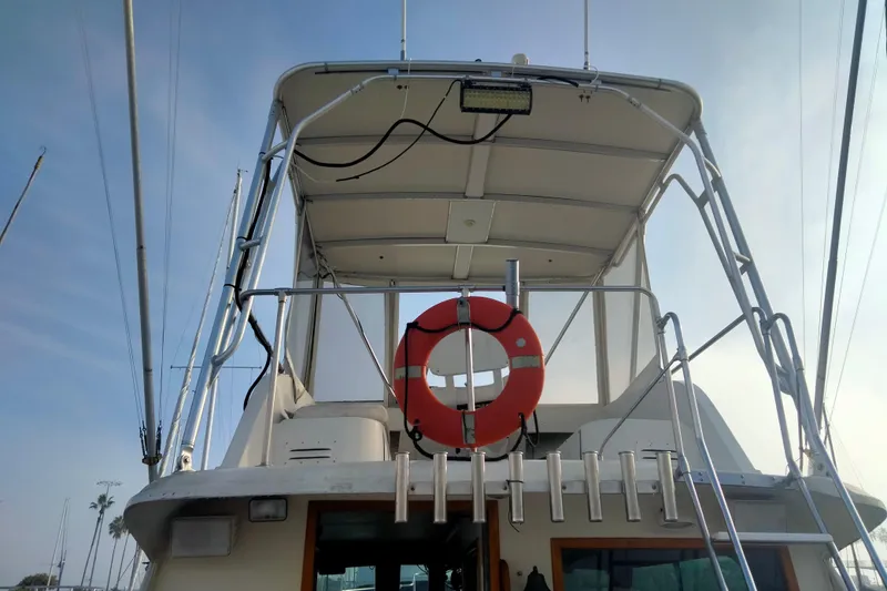 Slide: The Image of 1975 Hatteras 36 Convertible boat with upper deck and life preserver. - 3