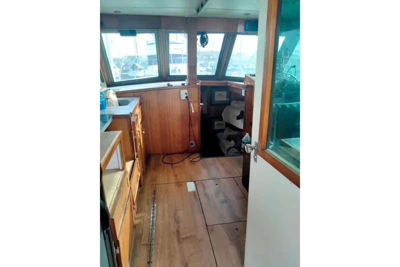 Slide: The Image of Interior of 1975 Hatteras 36 Convertible boat with wooden cabinetry and windows. - 5