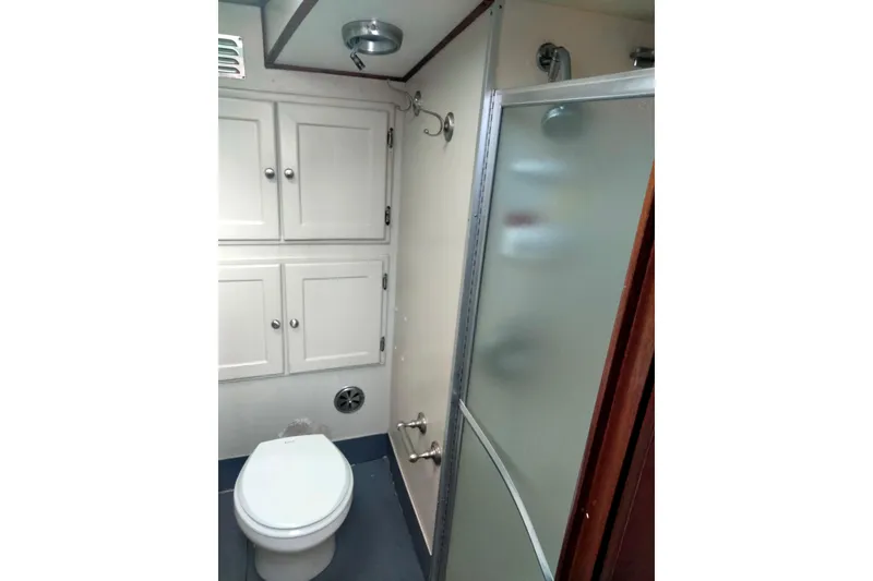 Slide: The Image of Bathroom interior of 1975 Hatteras 36 Convertible yacht with shower and storage cabinets. - 6