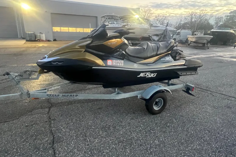 The Image of 2023 Kawasaki Jetski Ultra 310LX-S on trailer in parking lot at sunset. - 1
