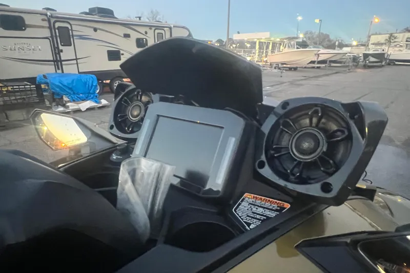 Slide: The Image of 2023 Kawasaki Jetski Ultra 310LX-S dashboard with speakers, parked near RVs and boats. - 22