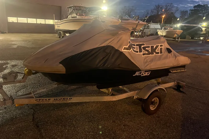 Slide: The Image of Covered 2023 Kawasaki Jetski Ultra 310LX-S on trailer at dusk in a boatyard. - 25