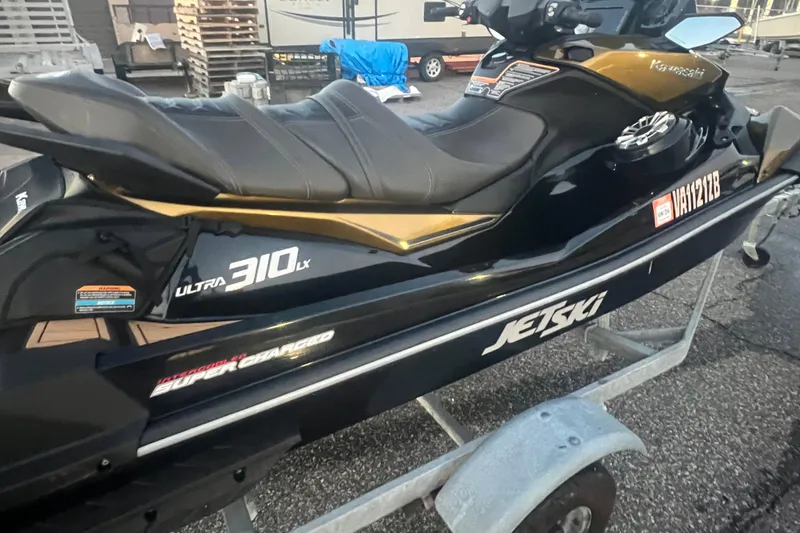 Slide: The Image of 2023 Kawasaki Jetski Ultra 310LX-S on trailer, black and gold design. - 6