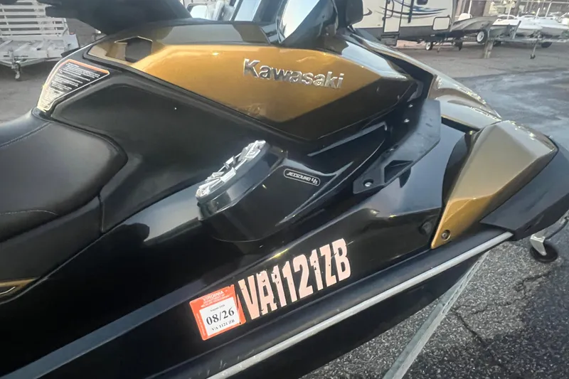 Slide: The Image of 2023 Kawasaki Jetski Ultra 310LX-S, black and gold, parked on a trailer. - 8