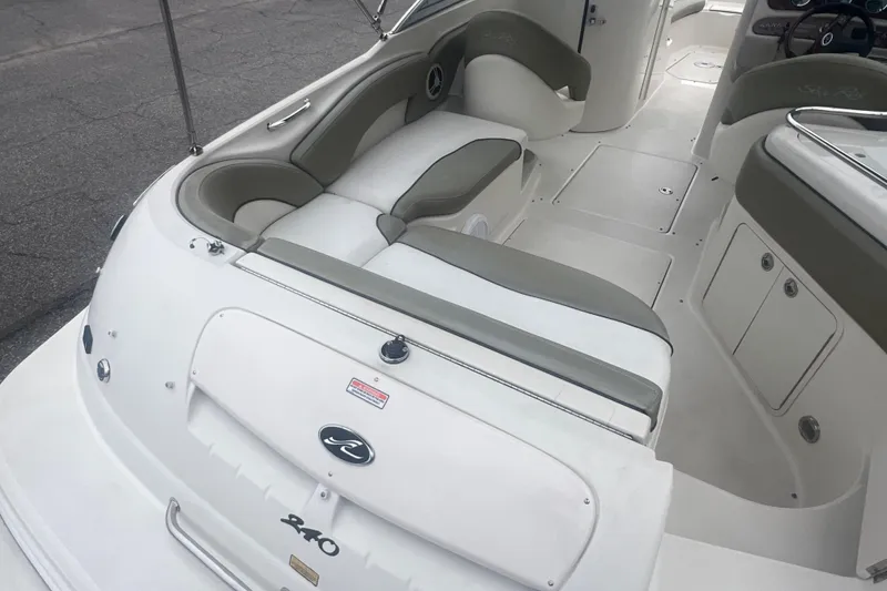 Slide: The Image of 2006 Sea Ray 240 Sundeck boat interior with seating and steering wheel. - 11