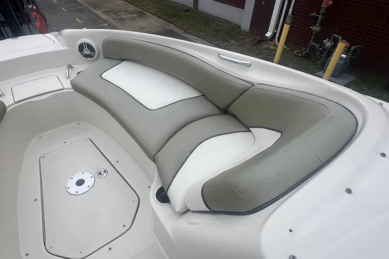 Slide: The Image of 2006 Sea Ray 240 Sundeck boat interior with cushioned seating and speaker. - 16