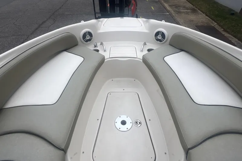 Slide: The Image of 2006 Sea Ray 240 Sundeck boat interior with beige and white cushioned seating. - 17