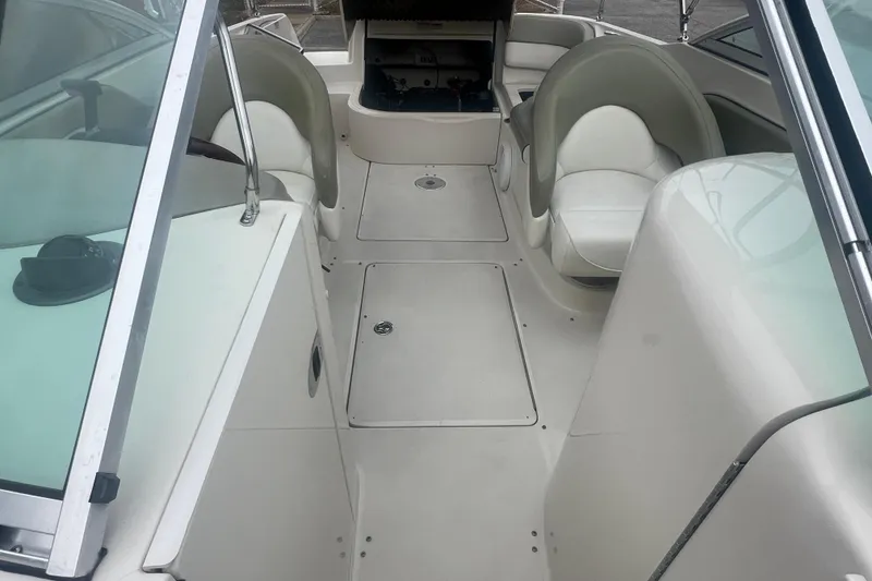 Slide: The Image of 2006 Sea Ray 240 Sundeck boat interior with cushioned seating and speakers. - 18
