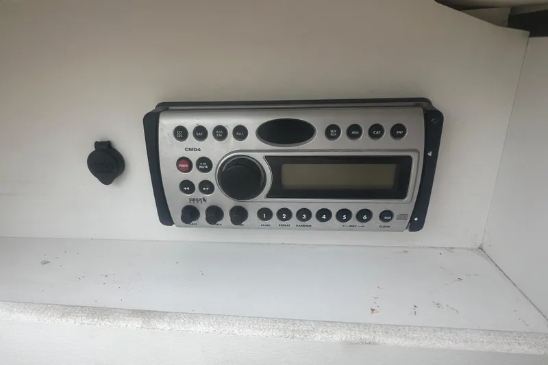 Slide: The Image of Storage compartment in a 2006 Sea Ray 240 Sundeck boat, featuring carpeted interior. - 20