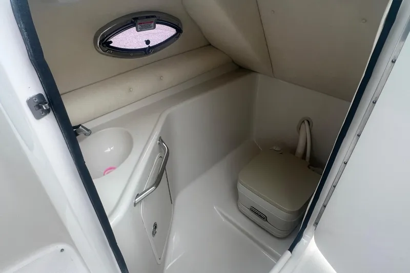 Slide: The Image of 2006 Sea Ray 240 Sundeck interior with sink and portable toilet. - 22