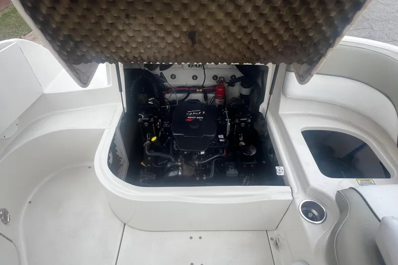 Slide: The Image of 2006 Sea Ray 240 Sundeck interior bathroom with sink and portable toilet. - 23