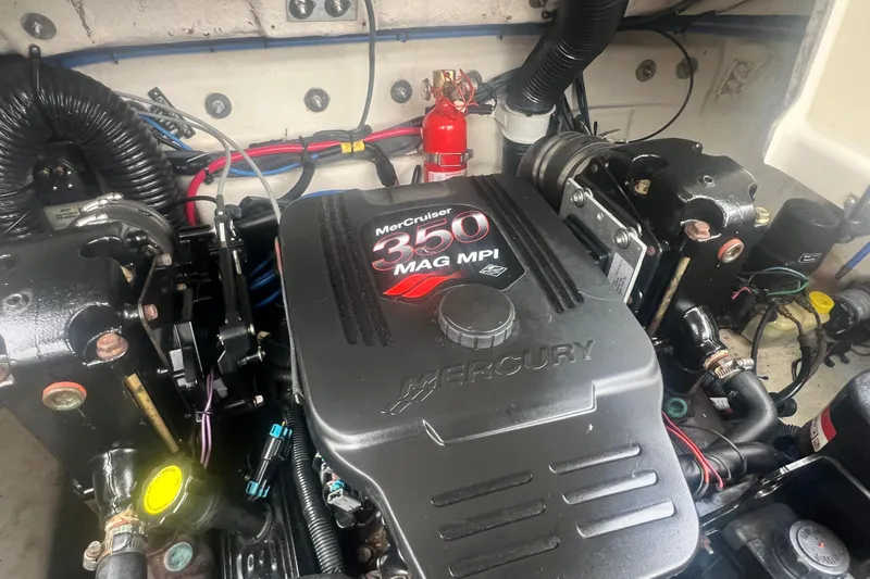 Slide: The Image of Engine compartment of a 2006 Sea Ray 240 Sundeck boat with open hatch. - 24