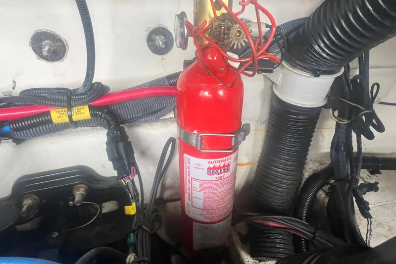 Slide: The Image of Engine compartment of a 2006 Sea Ray 240 Sundeck with visible batteries and wiring. - 26