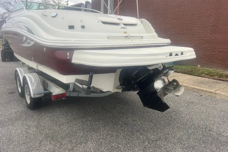 Slide: The Image of 2006 Sea Ray 240 Sundeck boat on trailer, parked outside a building. - 3