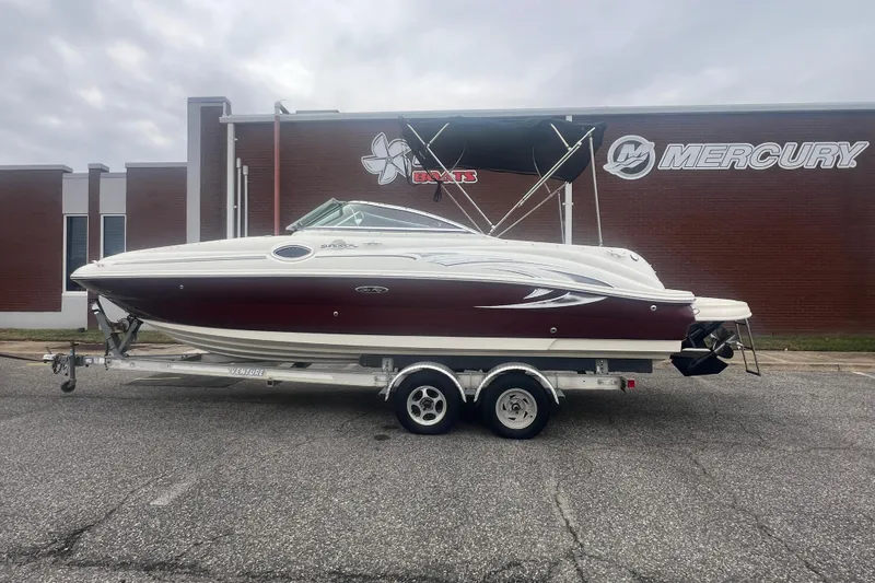 Slide: The Image of 2006 Sea Ray 240 Sundeck boat on trailer, parked outside Mercury building. - 30
