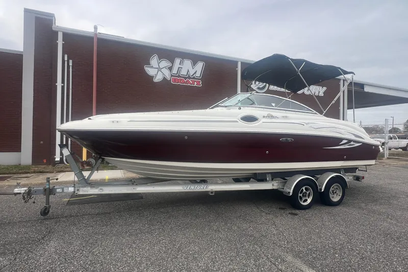 Slide: The Image of 2006 Sea Ray 240 Sundeck boat on trailer outside HM Boats dealership. - 31