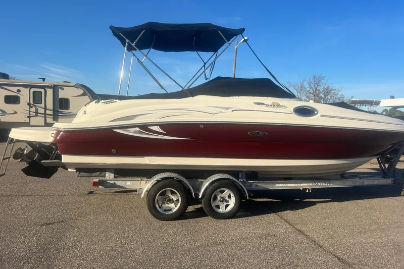 Slide: The Image of 2006 Sea Ray 240 Sundeck boat on trailer, featuring a red and white design. - 35