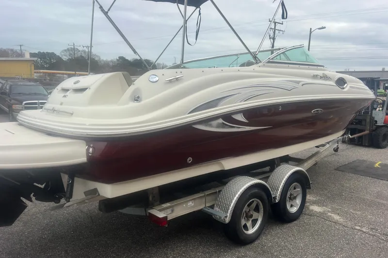 Slide: The Image of 2006 Sea Ray 240 Sundeck boat on trailer, rear view with propeller visible. - 5