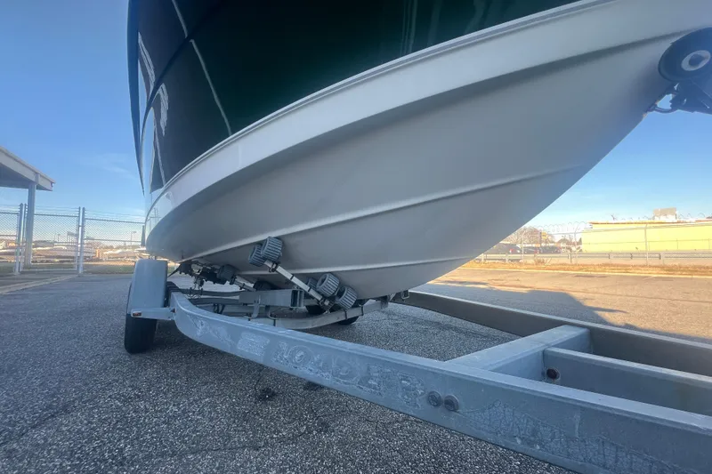 Slide: The Image of 2004 Trophy 2352 Walkaround boat on trailer, parked outdoors. - 10