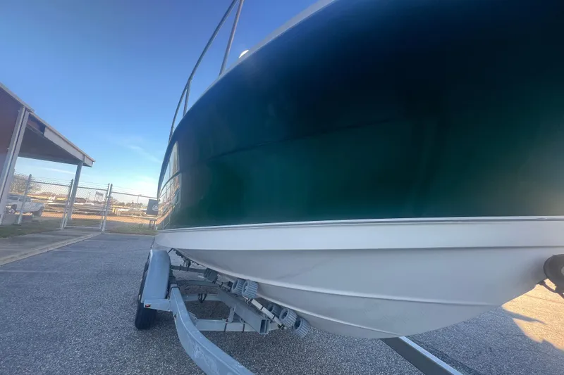 Slide: The Image of 2004 Trophy 2352 Walkaround boat on trailer, parked outdoors. - 11