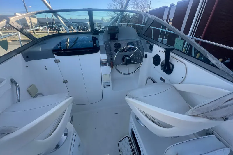 Slide: The Image of 2004 Trophy 2352 Walkaround boat interior with steering wheel and seating. - 12