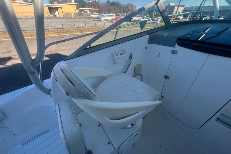 Slide: The Image of 2004 Trophy 2352 Walkaround boat interior with white seating and dashboard. - 14