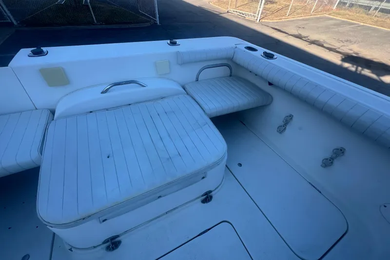 Slide: The Image of 2004 Trophy 2352 Walkaround boat interior with cushioned seating and storage. - 16